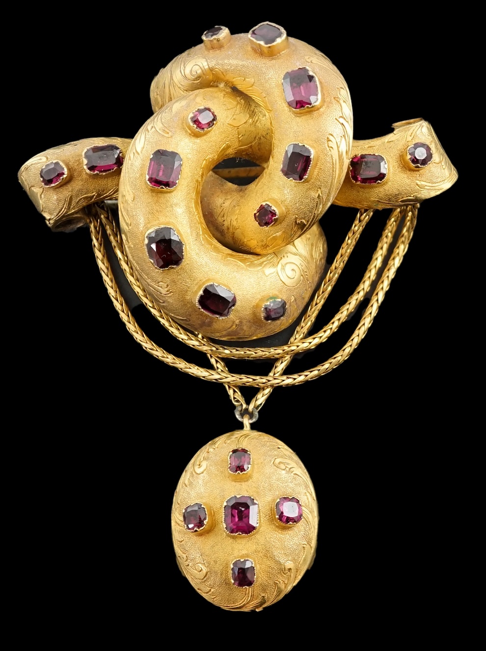 A Victorian textured gold and garnet cluster set drop 'knot' brooch